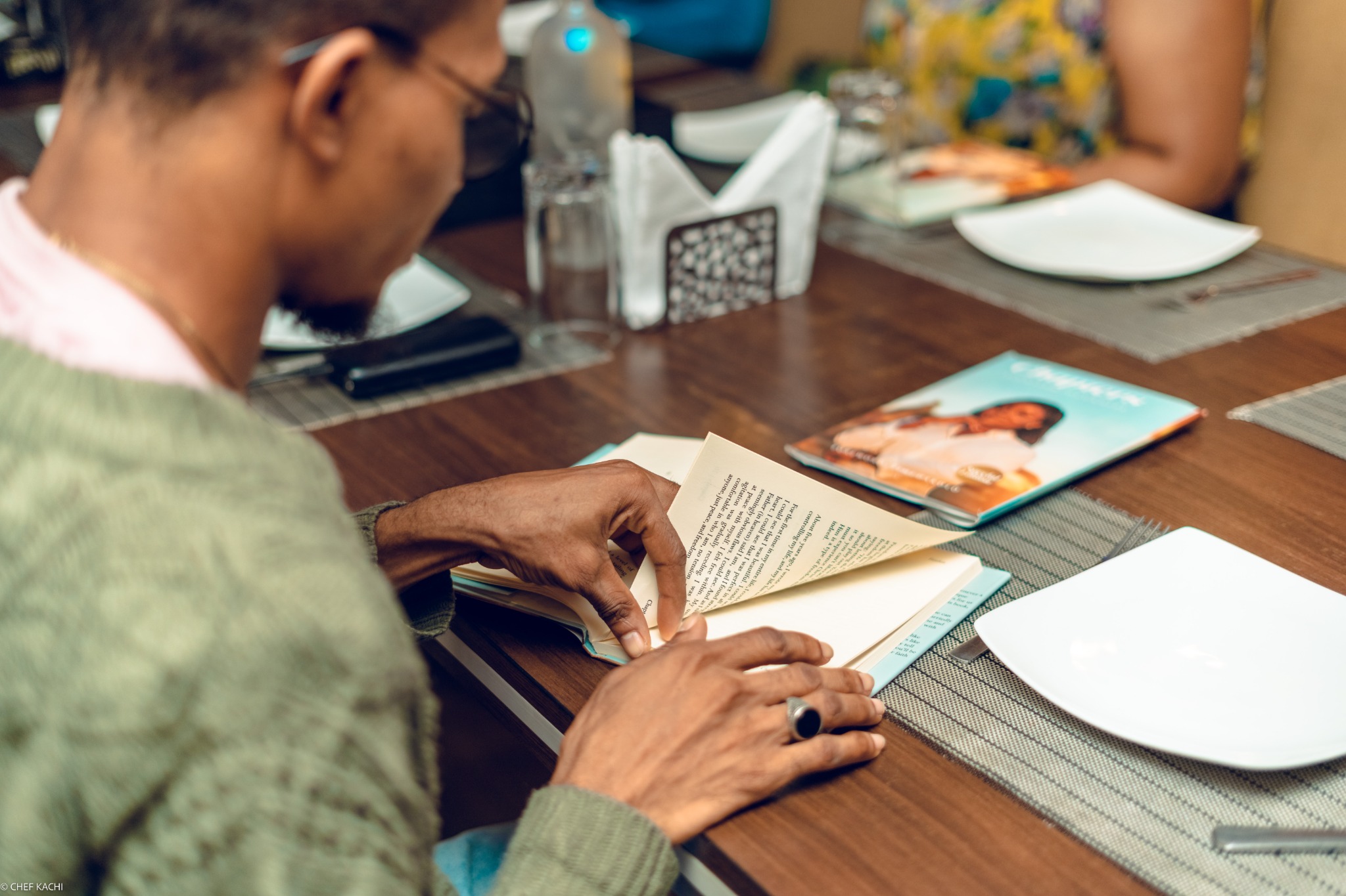 Participant reading a CHAPTERS book at a table.